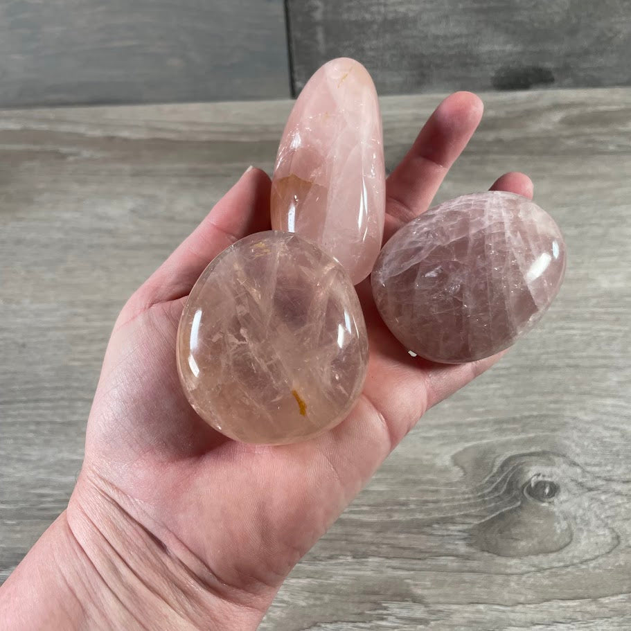 Wholesale rose quartz polished gemstones shaped into smooth handheld palm stones