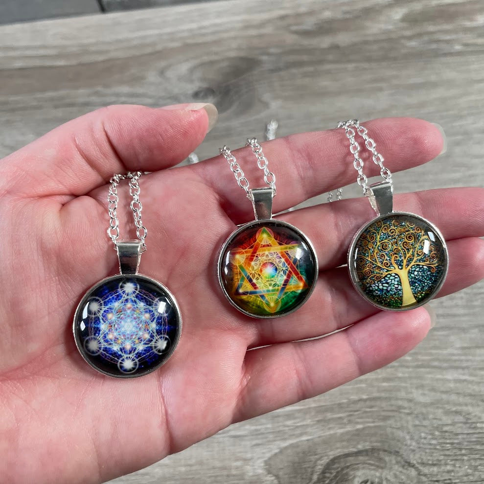 Assorted silver tone metal necklaces with spiritual New Age glass pendant designs