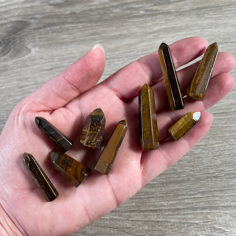 Polished tiger eye small gemstone obelisk from Brazil for crystal displays and gift shops.