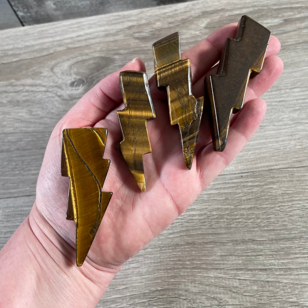 Tiger eye polished gemstone lightning bolt carvings measuring approximately 2 to 3 inches
