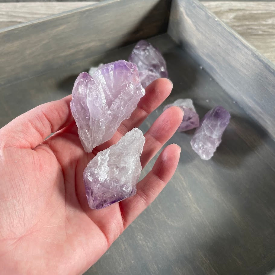 Wholesale raw amethyst gemstones in assorted lavender and violet shades for crystal shop inventory