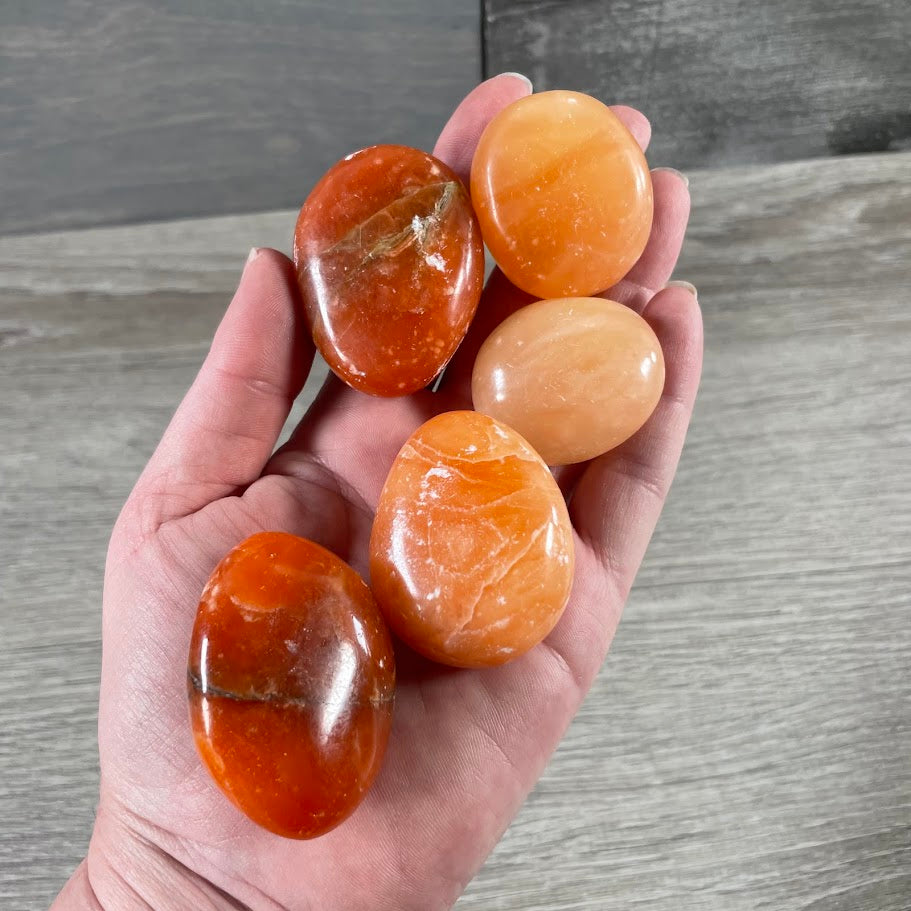 orange calcite crystal palm stones wholesale polished gemstones
