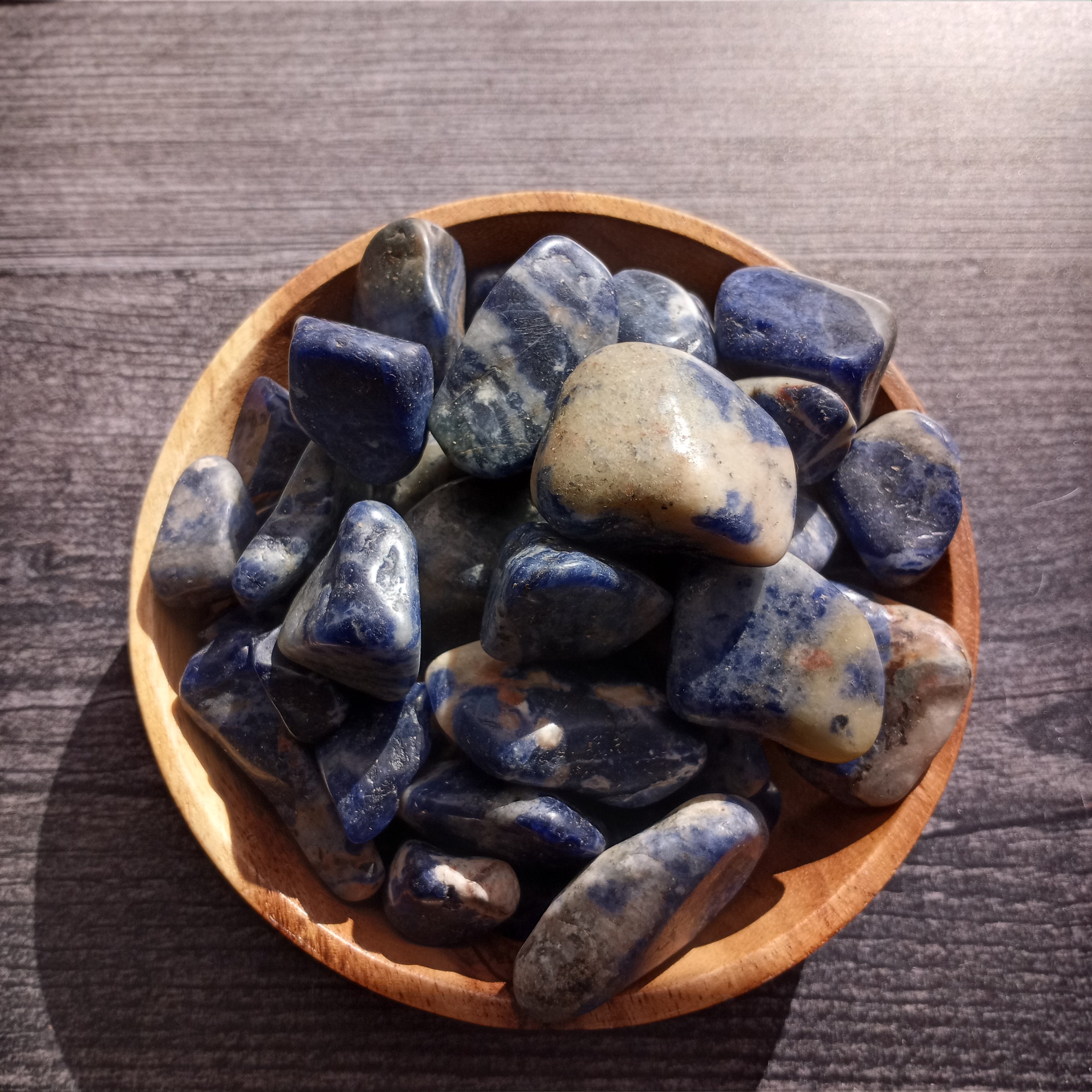 Bright blue Sodalite in a bowl.