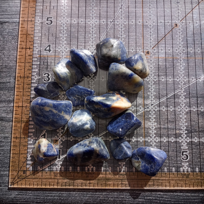 Bright blue nuggets of sodalite on a ruler