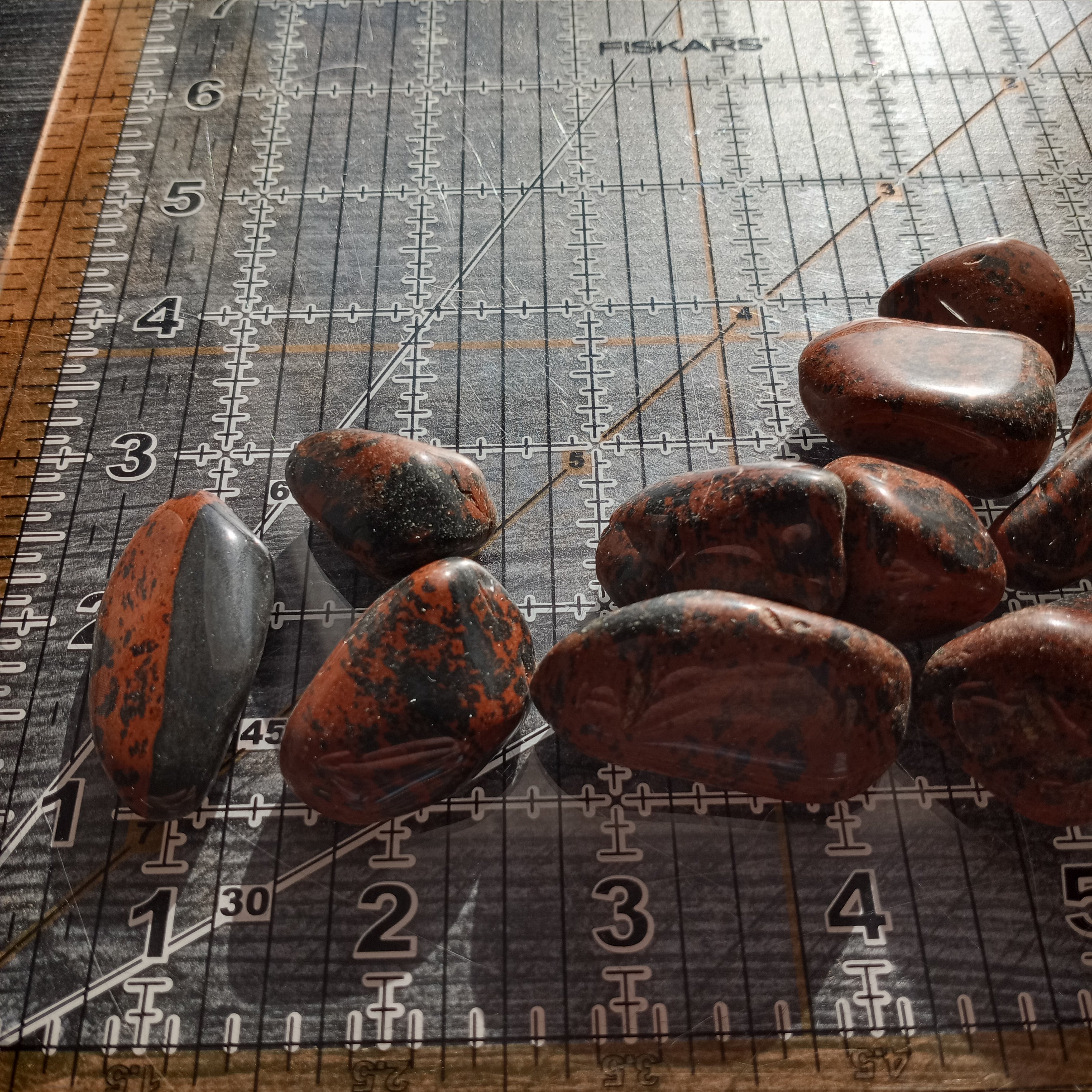 Mahogany Obsidian on a ruler grid