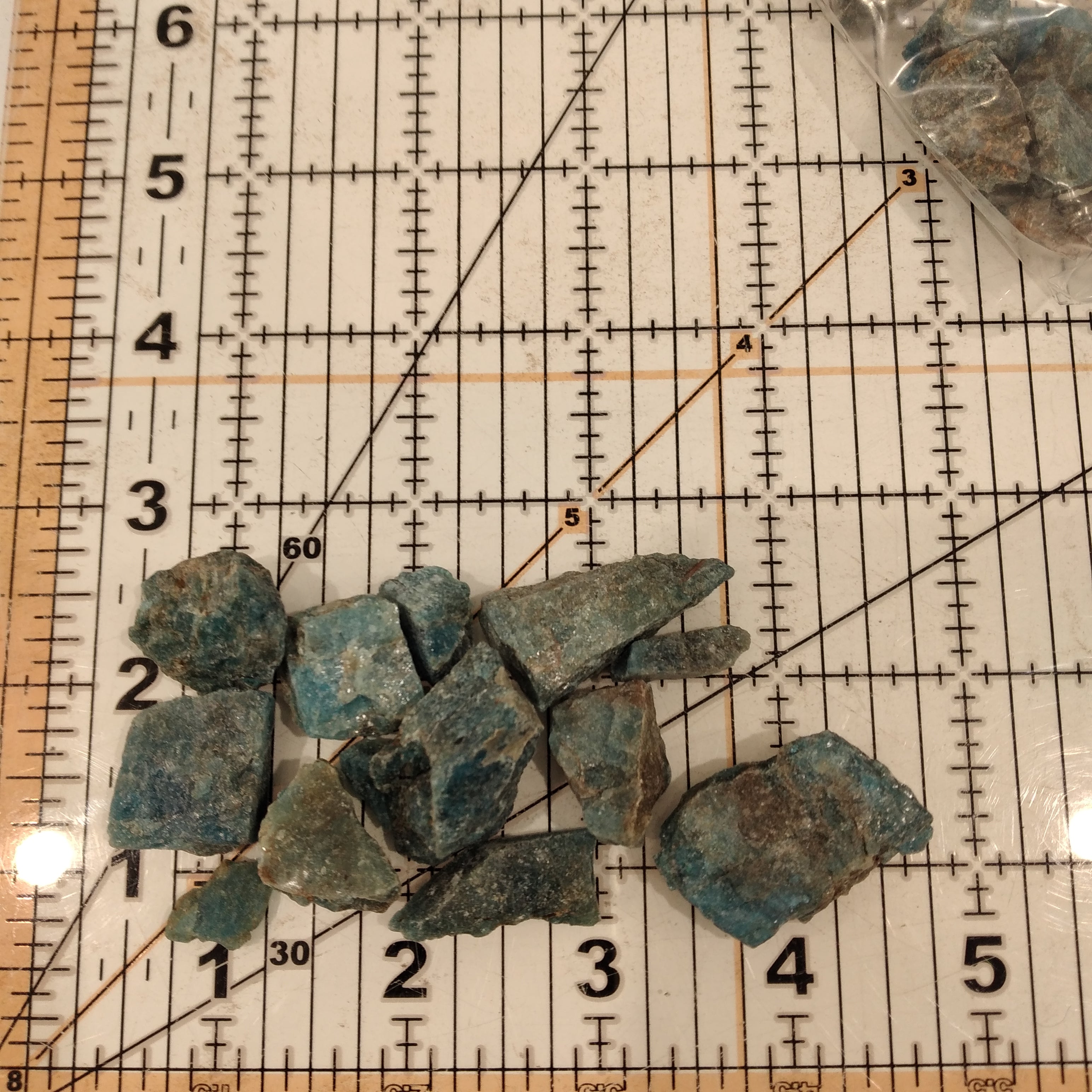 Rough Blue Apatite on a sizing grid.