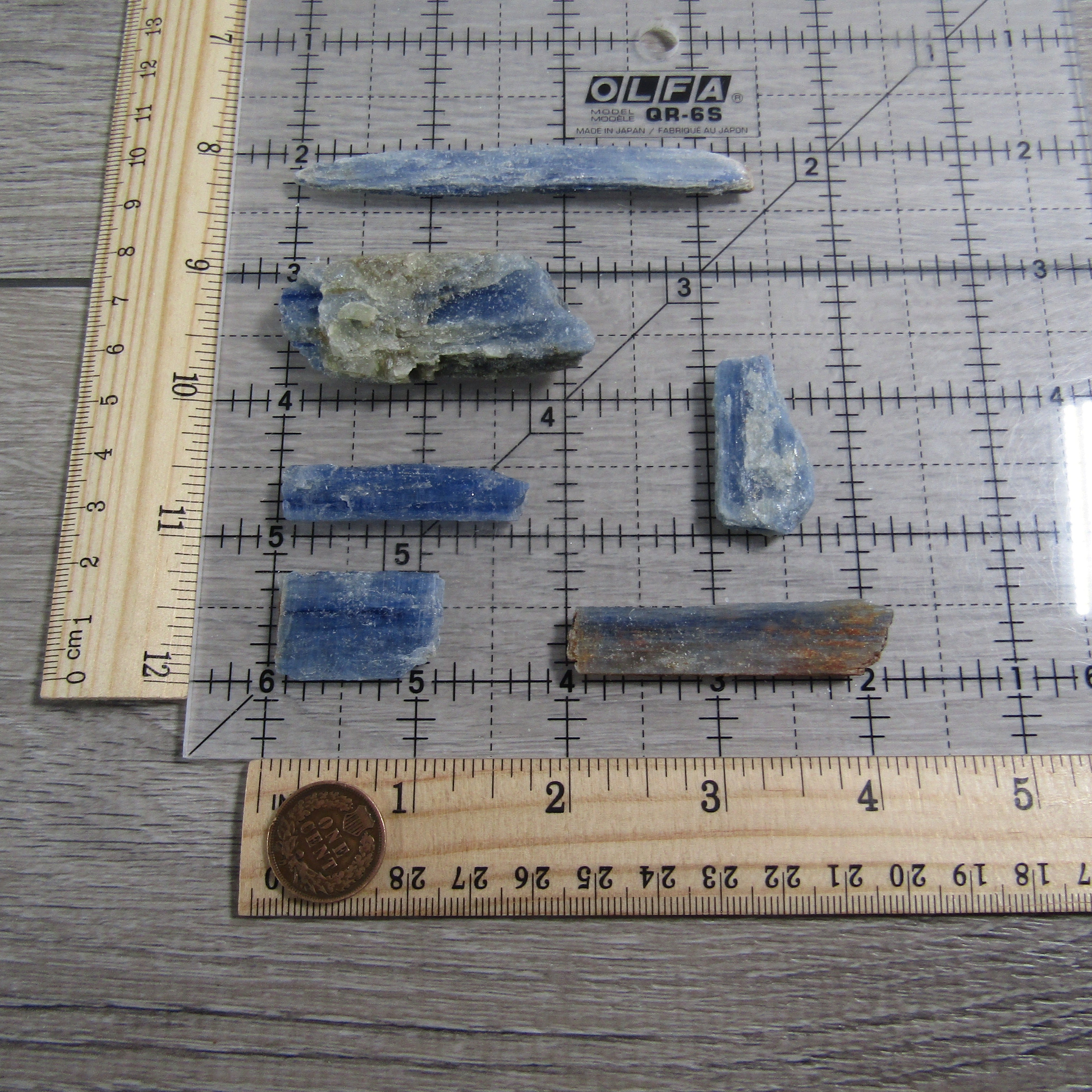 Blue Kyanite blades on a ruler grid