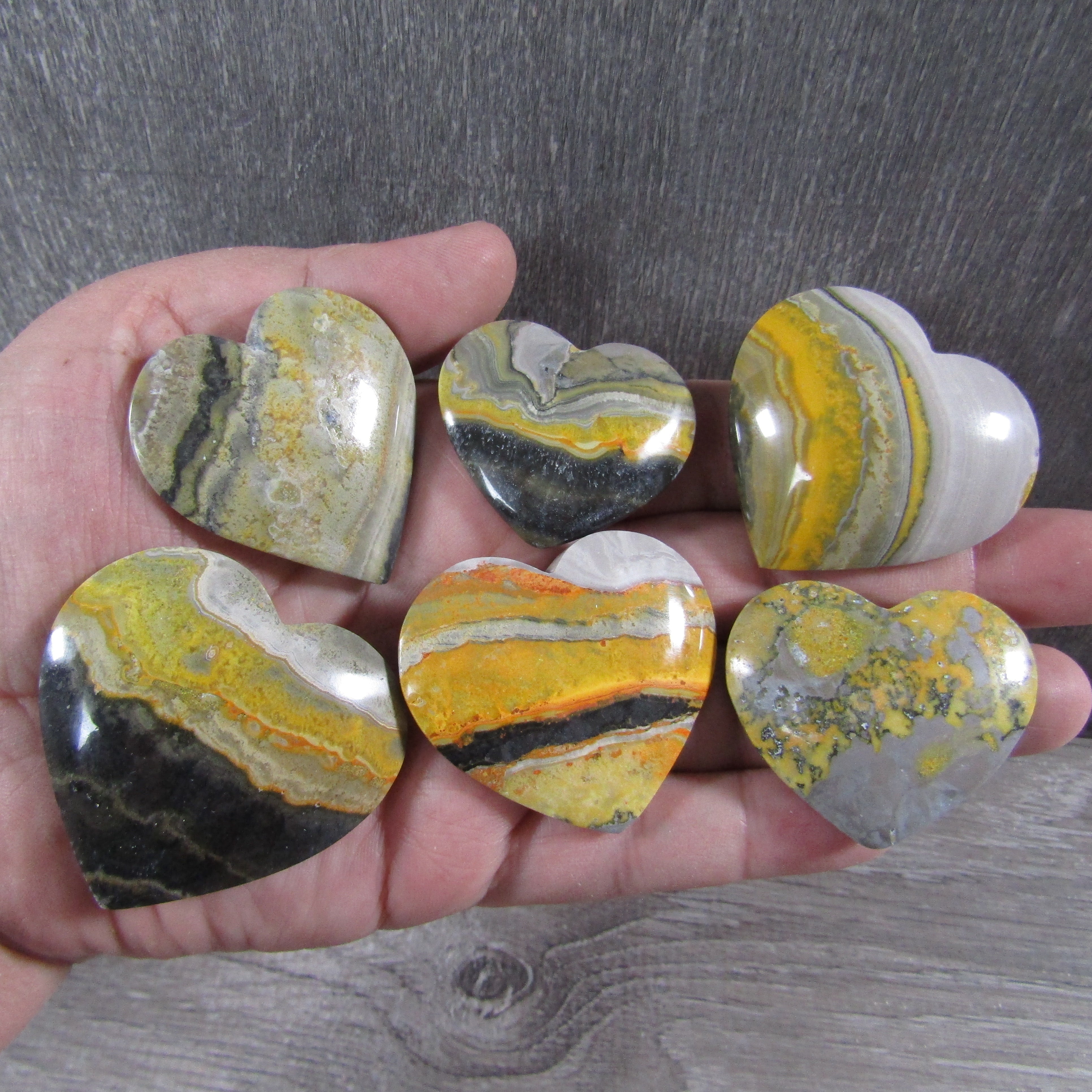 Polished Bumble Bee Jasper heart-shaped crystal with yellow and black bands for wholesale resale.