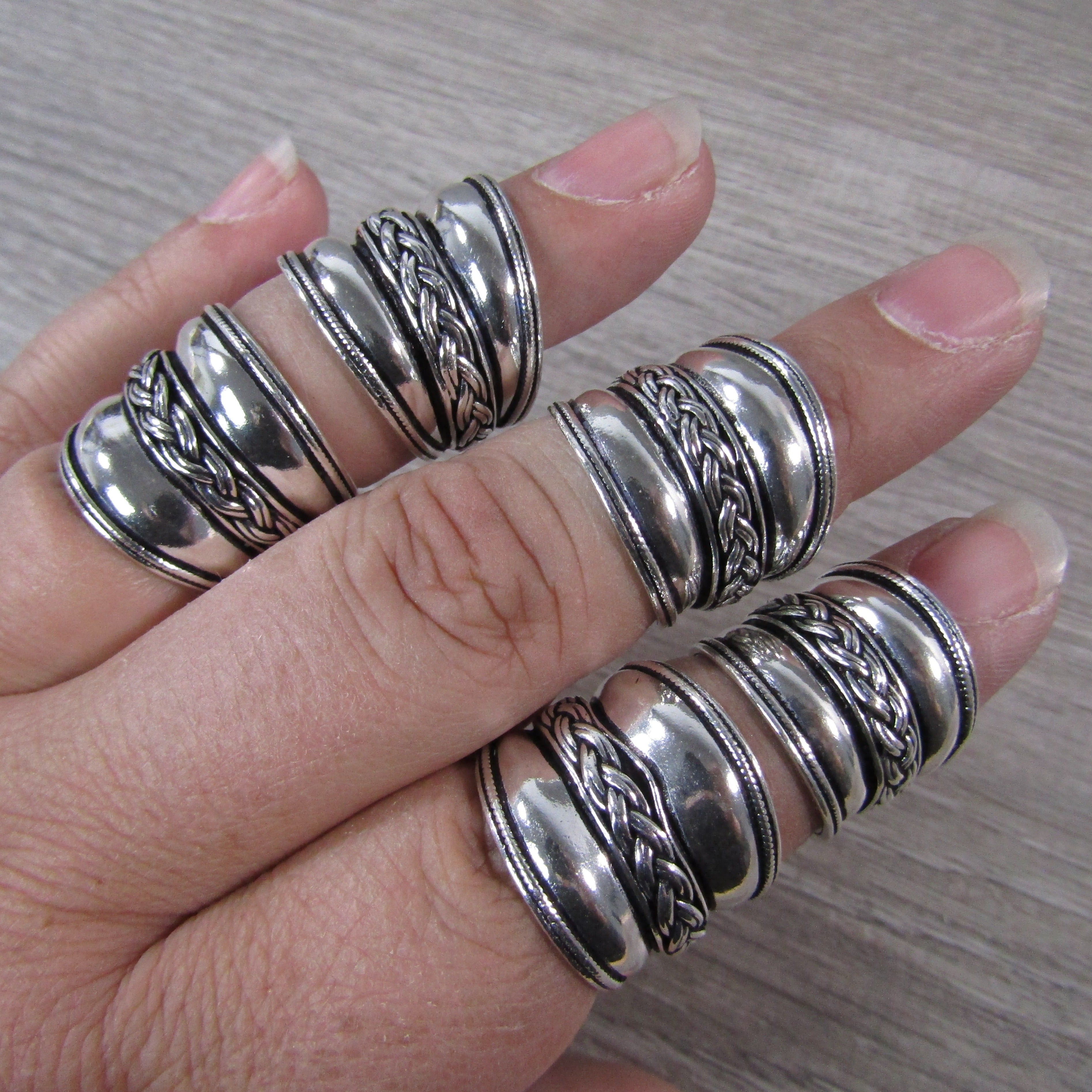 silver wide ring with braid design in the middle