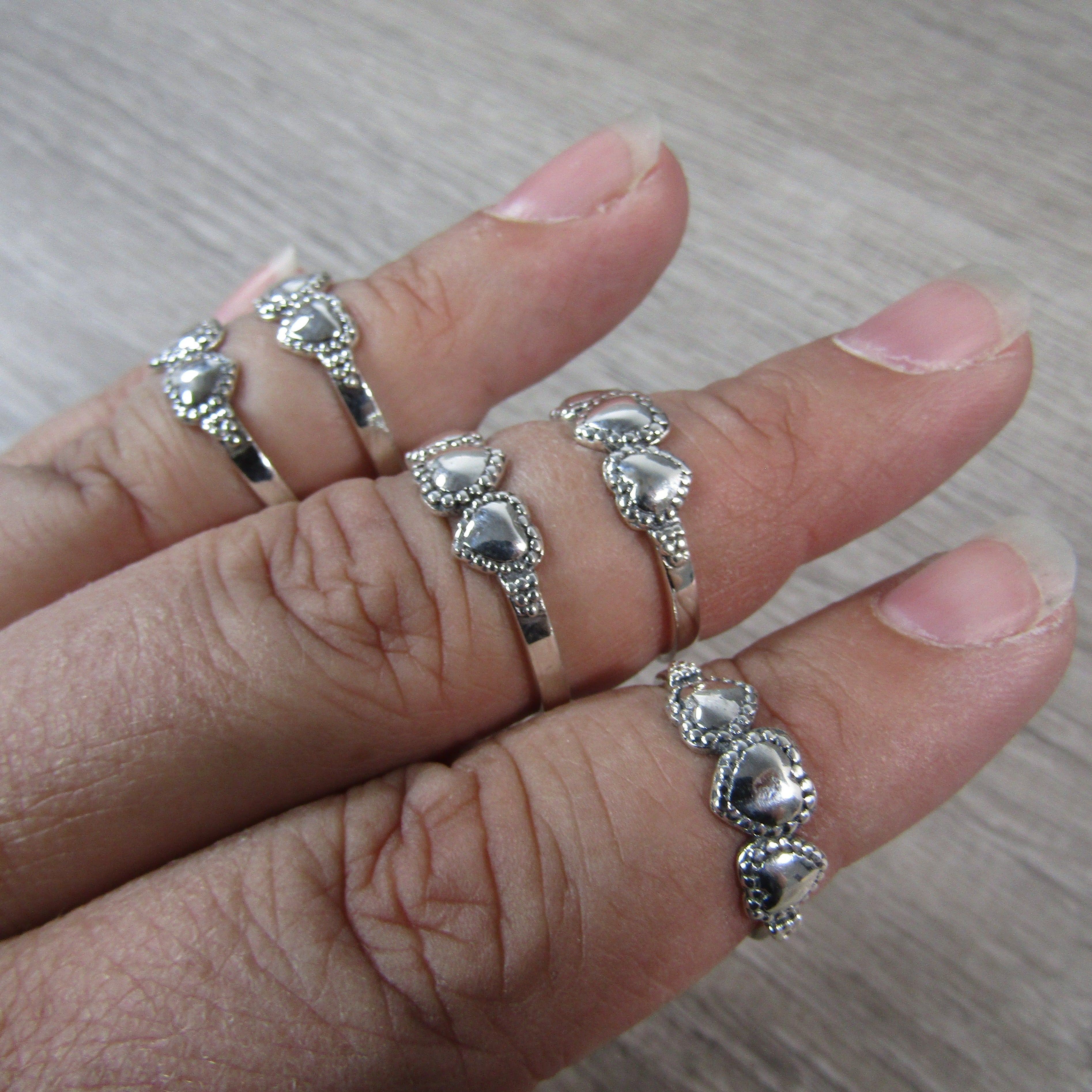 silver ring with 3 hearts