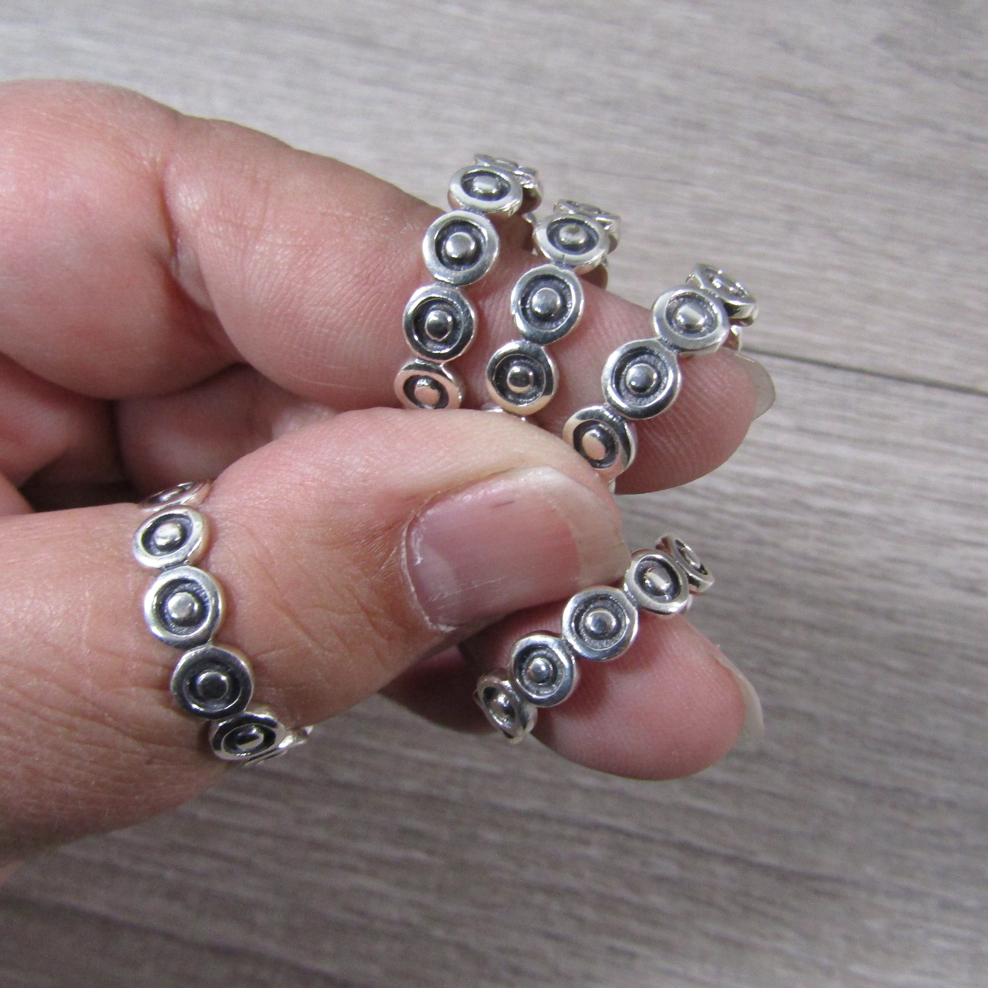 silver ring band with circles and dots