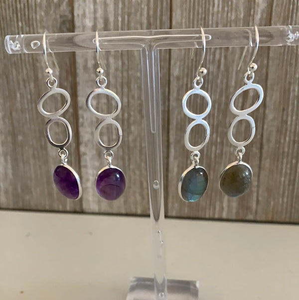 sterling silver earring with two loops and a set crystal gemstone on the end